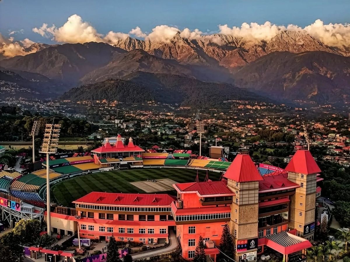 Dharamshala cricket stadium with the Dhauladhar range behind the town
